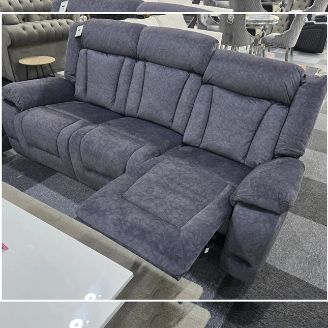 Gray reclining sofa in a showroom setting