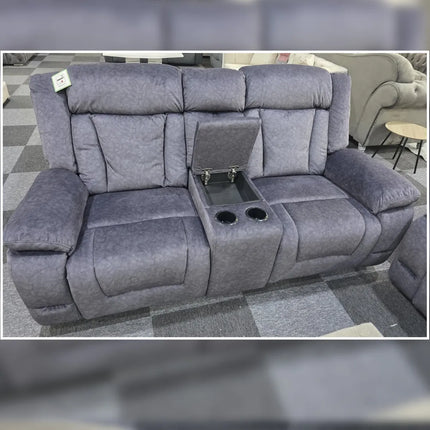 Gray recliner sofa with cup holders and armrest storage in a showroom setting.