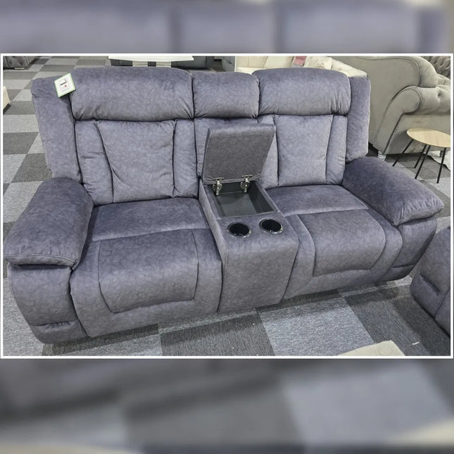 Gray recliner sofa with cup holders and armrest storage in a showroom setting.