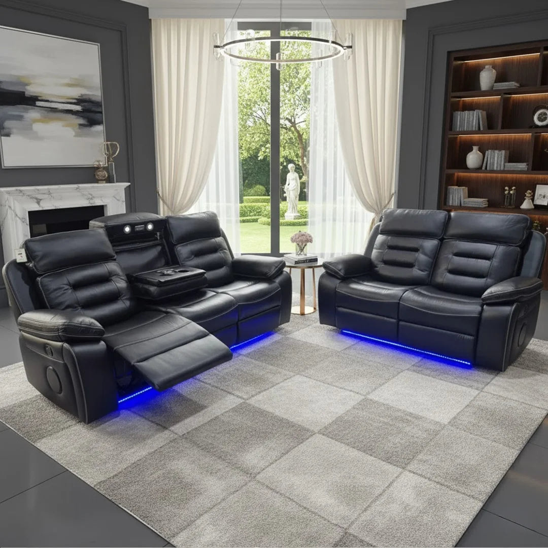 Modern living room with black leather recliner sofa set, large window, and decorative items.