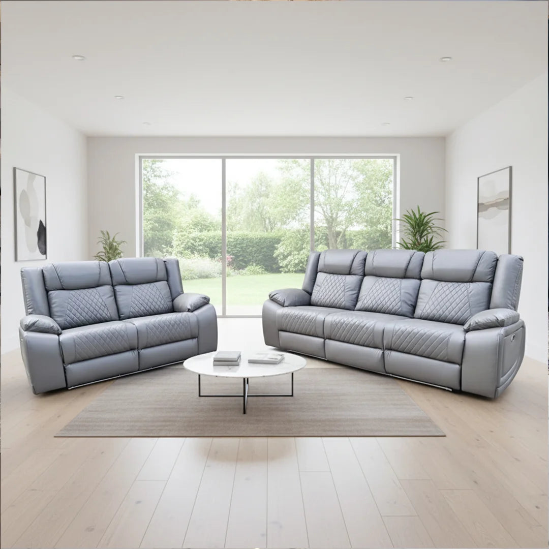 Gray leather sofa set in a modern living room with large windows.