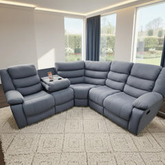 Gray sectional sofa in a living room with large windows.